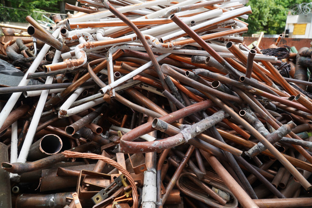 A large pile of copper scrap, copper tubes, and non-ferrous metal